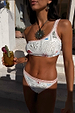 Cream Palma One Shoulder Bikini Top with a sun motif print and orange crochet trim, shown with matching bottoms.