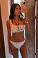 Cream Palma One Shoulder Bikini Top with hand-painted sun motifs and orange crochet trim in a mirror selfie.