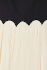 Black and Cream Monika Dress detail featuring a scalloped corset-style top and cream pleated tulle mesh skirt.