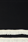 Black and Cream Fringe Jake Skirt detail showing the premium black knit fabric with rows of cream Western-style fringe.