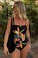 Black Banana Bandeau Swimsuit with multi-colour embroidered motifs and ruched tie sides in a tropical setting.