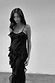 Black Molly Dress with tiered ruffles along the neckline and skirt, featuring thin adjustable straps.