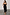 Thumbnail for Black Molly midi dress with tiered ruffles and spaghetti straps, worn by a model in UK size 8/ US 4.