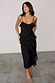Black Molly midi dress with tiered ruffles and spaghetti straps, worn by a model in UK size 8/ US 4.