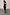 Thumbnail for Black Molly Dress with tiered ruffles, spaghetti straps and a side slit, worn by a model in a UK size 8/US 4.