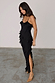 Black Molly Dress with tiered ruffles, spaghetti straps and a side slit, worn by a model in a UK size 8/US 4.