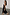 Thumbnail for Black Molly midi dress featuring tiered ruffles, adjustable straps and a side slit on a model.