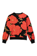 Black Poppy Cardigan featuring an iconic red floral print on a soft luxe knit with a ribbed hem and cuffs.