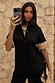 Black Raffia Shirt with raffia fringed sleeves and shell-style buttons, styled in a mirror selfie.