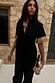 Black Raffia Shirt with fringed sleeve trims and shell buttons, styled with a shell necklace and raffia clutch.