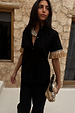 Black Raffia Shirt with fringed sleeve trims and shell buttons, styled with a shell necklace and raffia clutch.