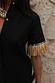 Thumbnail for Black Raffia Shirt featuring tan raffia fringe on the sleeve and textured crochet shell-style buttons.