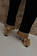 Black Raffia Marra Trousers featuring tan raffia fringe at the hem, styled with woven raffia sandals.