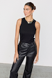 Black Ribbed Tank in soft stretch fabric, styled as a wardrobe staple with black leather-look trousers.