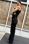 Black Scallop Detail Jeans featuring scalloped pockets and wide leg, styled with a black vest and ballet flats.