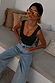 Black Scoop Neck Rib Tank in soft stretch rib, a wardrobe staple styled with light wash denim and sunglasses.