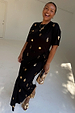 Black Shell Midi Leia Dress with gold shell prints and a wrap tie skirt on a model wearing size L.