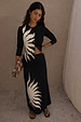 Black Sol Dorris Skirt with a hand-painted sun print, styled with a matching cardigan for a slinky jersey co-ord.