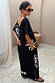 Black cotton Dolce Vita T-Shirt Dress with sun motifs and Greek graphics, showing the V-back and side pockets.