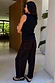 Thumbnail for Black Studded Barrel Jeans featuring a barrel leg and silver studs along the sides and back pockets.
