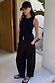 Black Studded Barrel Jeans with side stud details, styled with a sleeveless top and cap on a model.