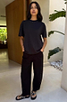 Black Studded Barrel Jeans featuring silver stud detailing along the sides, styled with a matching black t-shirt.