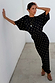 Black Tilly Dress in plisse with gold foil flecks, featuring a wide neckline and relaxed fit.