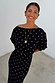Black Tilly Dress with gold foil flecks in plisse fabric, styled with an off-shoulder neckline.