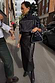 Thumbnail for Black Vegan Leather Jaspre wrap skirt with a tulip shaped tie, paired with a zip-up jacket in a London setting.