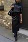 Black Vegan Leather Jaspre Wrap Skirt with a tulip tie, styled with a black zip jacket and boots.