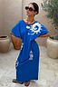 Thumbnail for Blue Dolce Vita T-Shirt Maxi Dress with white sun motifs and Greek artistry graphics in a patio setting.