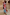 Thumbnail for Dolce Vita Mesh Dress in blue with red swirl and eye motifs on a model in a vacation setting.