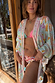 Blue Dreamer Maxi Kimono featuring palm and sun motifs in light blue, styled over a bikini for a vacation look.