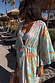 Blue Dreamer Maxi Kimono in light blue with sun and heart motifs, worn poolside with matching swimwear.