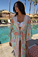 Blue Dreamer Maxi Kimono in light blue with star and heart motifs, styled poolside with a tie waist and tassels.