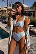 Blue Dreamer High Waist Brief featuring a vibrant sun print, styled poolside with a matching top and cover-up.