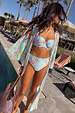 Blue Dreamer High Waist Brief in a bold sun and palm print, styled with a matching bikini top and robe poolside.