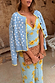 Blue Fawn Cheryl Cardigan with a spotted deer print and yellow trims, layered over a blue floral dress.