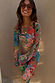 Blue Mari Aria Mesh Dress featuring a colourful paisley print and flared sleeves on a model in sunglasses.