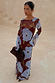 Burgundy & Blue Poppy Aria Dress in sheer mesh with flared sleeves, styled with a brown clutch and leopard print heels.