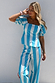 Blue and white stripe Kiki top with puffed sleeves and a peplum hem, styled with matching trousers.
