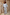 Thumbnail for Blue Stripe Balloon Trouser and top co-ord in cotton with gold studs, worn by a model against a stone wall.