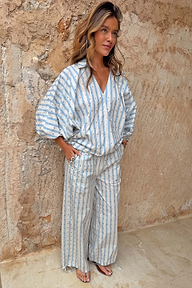Oversized Blue Stripe Cara Shirt with gold studs and voluminous sleeves, styled as a co-ord for a relaxed London look.