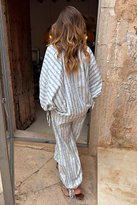 Blue Stripe Cara Shirt in cotton with gold studs and tie cuffs, styled as an NFD co-ord set from the back.