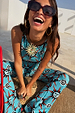 Blue Sun Foldover Trouser and vest with hand-painted sun and swirl motifs in bright blue jersey on a laughing model.