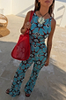 Blue Sun Foldover Trousers in a bright blue sun and swirl print, styled as a flared jersey co-ord for a summer look.
