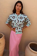 Blue Sun Hollie Cardigan in a baby blue soft touch knit with a pink sun print, paired with a pink satin skirt.