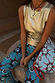 Blue Sun Foldover Trouser with sun motifs, styled with a gold metallic top and matching hand-painted print bag.