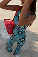 Blue Sun Foldover Trouser with hand-painted sun motifs, styled as a co-ord with a matching top and red bag.