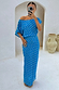 Blue Jacquard Tilly Dress with gold flecks and an off-the-shoulder neckline, styled for a vacation in a white archway.